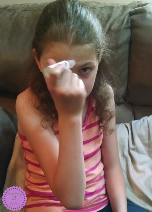 girl using EO roller bottle